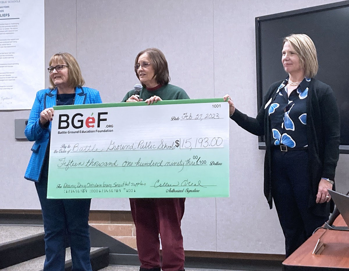 Battle Ground Education Foundation board members Linda Gellings, Colleen O’Neal and Cheri Dailey present a check for overdose preparedness efforts at the Battle Ground School Board meeting on Feb. 27.